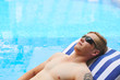© DragonImages - Sunbathing man