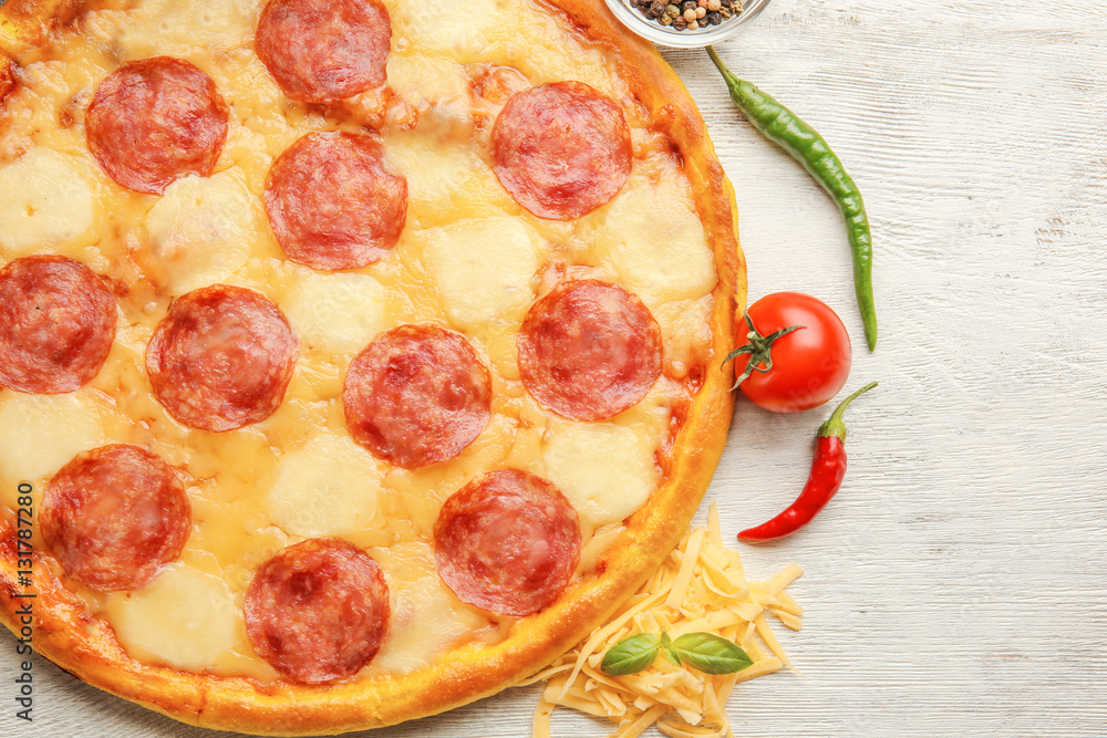 Tasty pizza on white wooden background