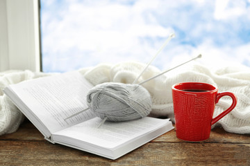 Poster - Cup of coffee and knitting on windowsill