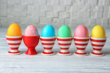 Wall Mural - Colorful Easter eggs on grey wooden table