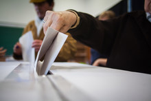 Person Voting At Polling Station