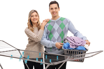 Poster - Couple behind a clothing rack dryer