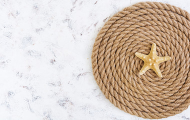 Rope and starfish on white background. Top view