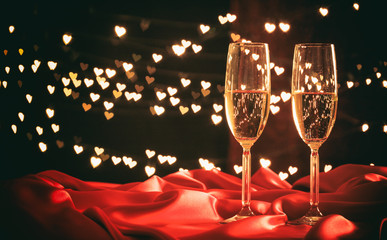 Champagne glasses on hearts bokeh background