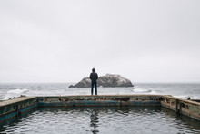 A Man Looks Out Onto The Pacific From The Sutro Baths In San Francisco, CA