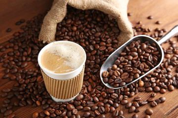 Canvas Print - Cup of coffee with beans and scoop on table