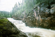 A Beautiful Scenery With A River Rapids In Finland