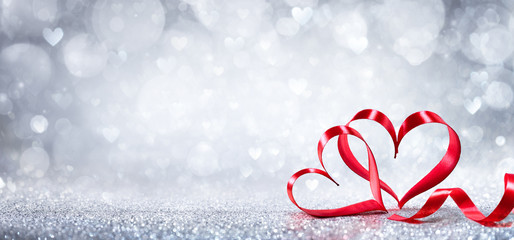 Wall Mural - valentines day decoration - ribbon shaped hearts on shiny background