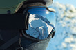 Close up shot of ski goggles with reflection of snowed mountains in it