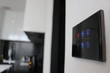 © Hi-Point - Electronic touch screen light and temperature control panel wall mounted in a modern apartment room.