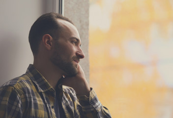 Wall Mural - Handsome depressed man near window