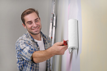 Sticker - Handsome young man painting wall in room