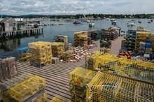 Lobster Traps On A Fishing Dock In Maine:  Stacks Of Lobster Pots Cover A Wooden Pier On A Bay In New England.
