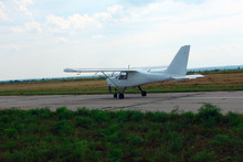 Small Sport Aircraft On The Runway At The Airport.