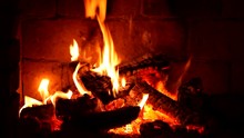 A Fire Burns In A Fireplace