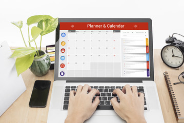 Wall Mural - business hand typing on a laptop keyboard with calender planner homepage on the computer screen. org