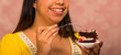 © Fotos 593 - Brunette woman holding small plate of chocolate cake with cream filling, grabbing bite using fork, showing to camera, pastry concept