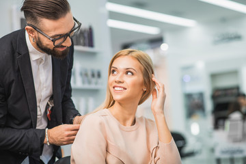 Wall Mural - Man and woman are looking at each other in salon