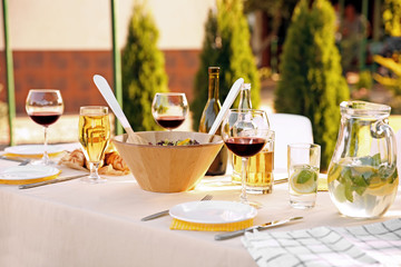 Poster - Table with food and drinks served for picnic in garden