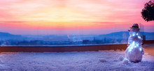 Cute Snowman Watching The Sun Goes Down On Rooftop Terrace