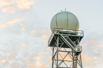 a doppler weather radar at sunset against a blue sky background. copy space on top.
