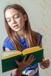 © elen31 - education and school concept - little student girl studying at school reading a book aloud