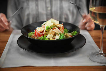 Poster - Woman having delicious dinner in cafe, closeup