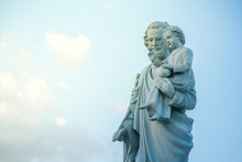 Classical Statue Of Saint Joseph With Child Jesus On Blue Sky.
Joseph Is A Figure In The Gospels, The Husband Of Mary,
Mother Of Jesus And Is Venerated As Saint Joseph In The Catholic Church.
