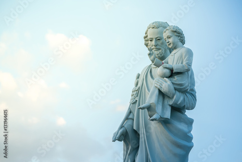 Cuadros en Lienzo classical statue of Saint Joseph with child Jesus on blue sky