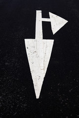 White forward traffic arrow on road