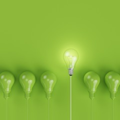 Wall Mural - Green pantone light bulbs with glowing one different idea on pastel green background. minimal concept. top view.