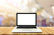 © pattarawat - Laptop Empty top wooden table and blur with bokeh background. Fo