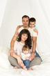 © irena_geo - Family. Father, mother, son, daughter sitting on the bed