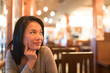 © Urbanscape - Tanned Asian girl thinking and looking upward to copy space, wondering menu to order for dinner, restaurant advertising concept