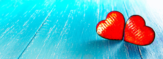 Poster - Two ceramic hearts on the blue, wooden table