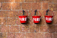 Red Fire Bin Contain The Sand On Brick Wall Background