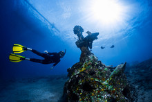 Free Diver Exploring The Underwater Statue In A Tropical Sea