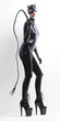 © Richard Semik - standing woman wearing latex clothes with a whip