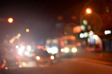 Artistic style - Defocused urban abstract texture ,blurred background with bokeh of city lights from car on street at night, vintage or retro color tone