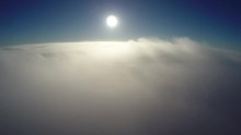 Aerial Bird-eye View Flying Lower Altitude Moving Into Clouds Beautiful Settings Showing First The Contract Of Sunshine Blue Sky And White Grey Clouds Below Then Only The Misty Weather Background 4k