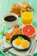 Summer breakfast - eggs, bacon, toast, jam, coffee, juice