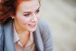 © raisondtre - Portrait of charming smiling girl with bright red brown hair on blurred background, side view closeup.