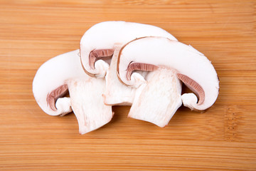 Fresh white mushrooms isolated on a wood background