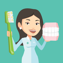 Poster - Dentist with dental jaw model and toothbrush.