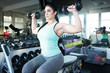 © Mat Hayward - Strong, determined and beautiful woman lifting weights in gym