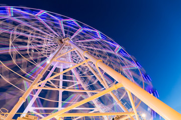 Wall Mural - Ferris Wheel at amusement park during evening