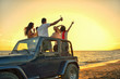 © FS-Stock - Five young people having fun in convertible car at the beach at sunset.
