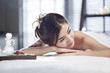 © Blue Jean Images - Beautiful young woman relaxing on massage table
