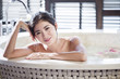 © Blue Jean Images - Beautiful young woman in bathtub with rose petals