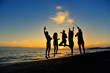 © FS-Stock - group of happy young people dancing at the beach on beautiful summer sunset
